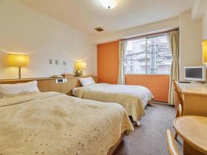 Postel nebo postele na pokoji v ubytování Kumagaya Royal Hotel Suzuki + 37 fotografií
