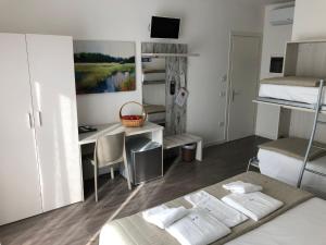a room with a bed and a desk with a computer at Alloggi Al Melograno in Marcon +9 photos