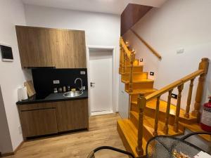 a kitchen with a sink and a staircase in a room at Vila D in Berat
