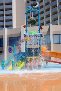 a group of children playing in a water park at Jupiter Albufeira Hotel - Family & Fun - All Inclusive in Albufeira +87 photos
