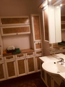 a bathroom with white cabinets and a sink at Charmant appartement lumineux in Hyères +5 photos