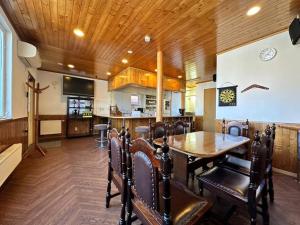 a dining room with a table and some chairs at Shakotan Detached House Stay in Shakotan