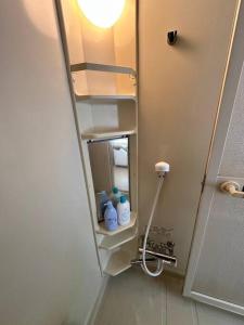 a bathroom with a shower stall with a mirror at Shakotan Detached House Stay in Shakotan +45 photos