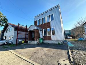 a house with a car parked in front of it at Shakotan Detached House Stay in Shakotan