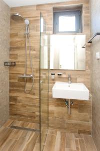 a bathroom with a sink and a shower at Olive Villas Beach Hotel in Sozopol