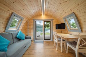 a living room with a couch and a table at Onich Hotel & Lochside Beach Pods in Onich