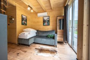 a living room with a couch and a large window at Rykowisko Korbielów 2 in Korbielów