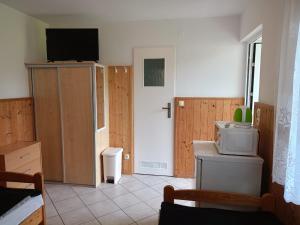 a living room with a tv on a wall and a door at Zielona Dolina in Łagów