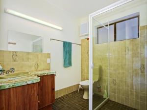 a bathroom with a toilet and a sink and a shower at Seaborne Escape - Port Willunga - C21 SouthCoast Holidays in Port Willunga