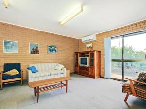 a living room with a couch and a tv at Seaborne Escape - Port Willunga - C21 SouthCoast Holidays in Port Willunga