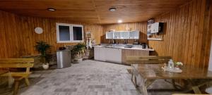 a kitchen with wooden walls and a table and chairs at Zielona Dolina in Łagów