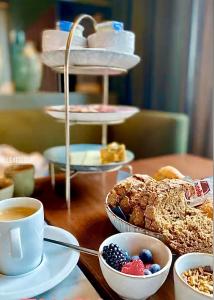 a table topped with plates of pastries and a cup of coffee at U Eat & Sleep Antwerp in Antwerp