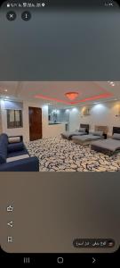 a living room with two beds in a room at كوخ ريفي تنومة in Tanomah