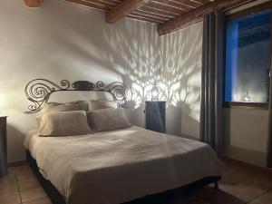 a bedroom with a bed with a shadow on the wall at Camping White Rock in Castellane
