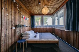 a bedroom with a bed in a wooden wall at Guboja in Nida