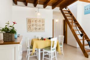 a dining room with a yellow table and chairs at Apartment Voltor 2 C By SunVillas Mallorca in Pollença