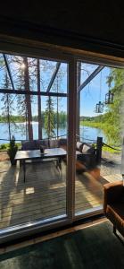 a screened in porch with a view of the water at Ternu Minivilla in Rovaniemi