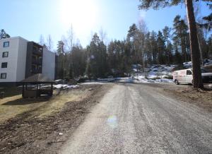 a dirt road with a van parked on the side at Forenom Serviced Apartments Hämeenlinna Katuma 3 in Hämeenlinna