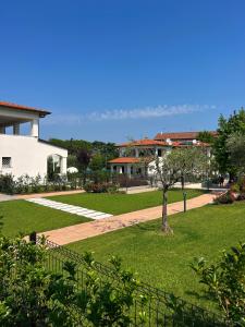 a view of a park with a building and a tree at RESIDENCE FIORE ROSSO in Sirmione