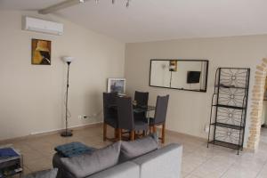 a living room with a couch and a table at Le Casot in Torreilles +4 photos