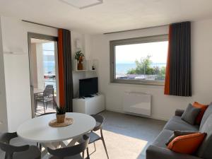 a living room with a couch and a table at Sirmio Apartments - Darsena Stay in Sirmione
