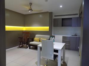 ZIBE Coimbatore by GRT Hotels في كويمباتور: مطبخ وغرفة طعام مع طاولة وكرسي