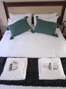 a hotel room with a bed with towels on it at Cozy Corner in Groblersdal