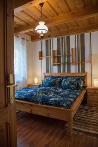 a bedroom with a bed with a blue comforter at Apartment in Balatonbereny - Balaton 18043 in Balatonberény