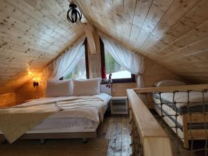 a bedroom with a bed in a tree house at Refugiul din Vama in Vama Buzăului
