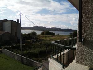 a view of the water from a balcony of a house at Apartamento en A Revolta, Sanxenxo in Sanxenxo