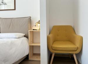 a bedroom with a chair next to a bed at Il Sigillo in Trieste