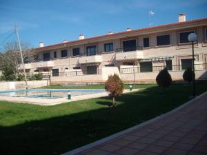 a large building with a yard in front of it at Apartamento en A Revolta, Sanxenxo in Sanxenxo