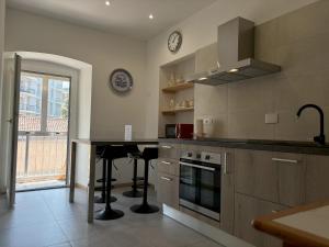 a kitchen with a counter and a table in it at Il Sigillo in Trieste