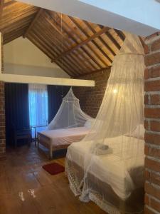 a bedroom with a bed with a mosquito net at Bunga Maliq Bungalow Lombok in Tetebatu