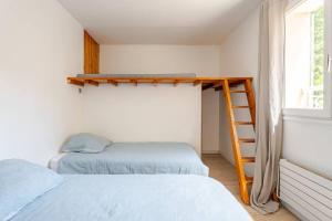 a bedroom with two beds and a ladder next to a window at Maison de vacances Marseille in Marseille +19 photos