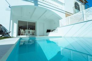 a swimming pool in a house with blue water at 272 Casa Sol ETV7727 by Mallorca Charme in Can Picafort