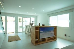 a living room with a flat screen tv on a wooden entertainment center at 272 Casa Sol ETV7727 by Mallorca Charme in Can Picafort