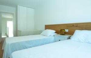 two beds in a bedroom with white sheets at 272 Casa Sol ETV7727 by Mallorca Charme in Can Picafort +21 photos