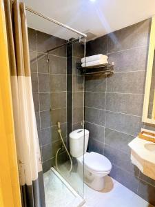 a bathroom with a toilet and a glass shower at Aodai Inn Saigon in Ho Chi Minh City