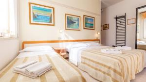Postel nebo postele na pokoji v ubytování Hotel Parco Fellini