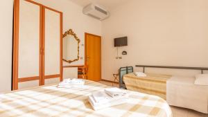 Postel nebo postele na pokoji v ubytování Hotel Parco Fellini