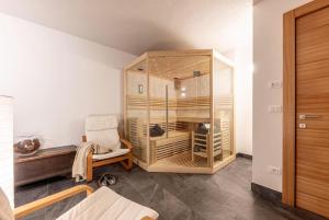 a room with a large wooden cabinet and a chair at Villa Speronella in San Martino di Castrozza