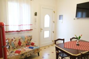 a living room with a couch and a table at Suite Laguna in Chioggia