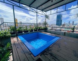 a swimming pool on the roof of a building at Stars Central Danang in Danang