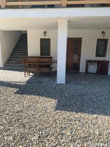 a bench in front of a building with stairs at Casa Mai in Vişeu de Sus