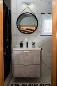 a bathroom with a sink and a mirror at Holiday House VUKI in Nedeščina