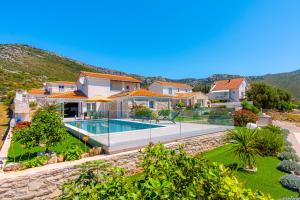 a villa with a swimming pool and a house at Villa Mirage with Private Heated Pool in Orebić