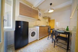 a kitchen with a washing machine and a table with chairs at Gest Short Rent Siena 3 in Siena