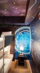 a bedroom with a mural of a star system at Residhome Val d'Europe in Mont&eacute;vrain