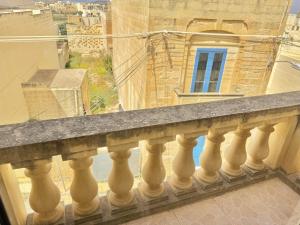 a balcony with a view of a building at St Anglu Xaghra - Quality Guest House in Xagħra